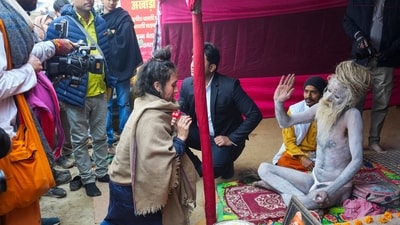 Mahakumbh, day 3: A devotee seeks blessings from a Naga sadhu during the ongoing Mahakumbh Mela 2025, at the Sangam in Prayagraj, Wednesday, Jan. 15, 2025. (PTI) Mahakumbh, day 3: A devotee seeks blessings from a Naga sadhu during the ongoing Mahakumbh Mela 2025, at the Sangam in Prayagraj, Wednesday, Jan. 15, 2025. (PTI)