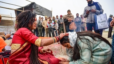 Mahakumbh, day 3: A devotee seeks blessings from a 'kinner sadhu' during the Mahakumbh 2025, at Sangam in Prayagraj, Wednesday, Jan. 15, 2025. (PTI) Mahakumbh, day 3: A devotee seeks blessings from a 'kinner sadhu' during the Mahakumbh 2025, at Sangam in Prayagraj, Wednesday, Jan. 15, 2025. (PTI)