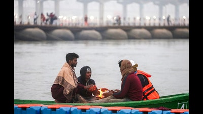 People warm themselves around a bonfire on the banks of the Ganga river during the ongoing ‘Maha Kumbh Mela’ festival, in Prayagraj (PTI) People warm themselves around a bonfire on the banks of the Ganga river during the ongoing ‘Maha Kumbh Mela’ festival, in Prayagraj (PTI)