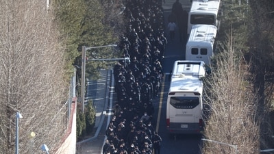 Police officers and investigators of the Corruption Investigation Office for High-ranking Officials leave the official residence of impeached South Korean President Yoon Suk Yeol, following his arrest, in Seoul, on January 15, 2025. (REUTERS)