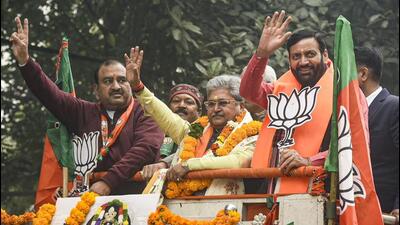 The BJP candidate from Karol Bagh constituency, Dushyant Kumar Gautam (centre), with party leader and Haryana chief minister Nayab Singh Saini (right) during a rally before filing his nomination papers for the Delhi assembly elections on Wednesday. (PTI Photo)