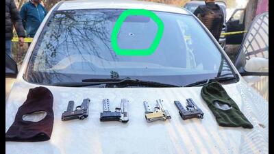 The seized car and the weapons after the shootout on Wednesday. (HT Photo)