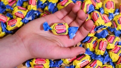 A boy holds a wrapped Dubble Bubble Bubble Gum candy in his hand, a product that uses Red Dye # 3, in this illustration photograph on December 27, 2024. The US Food and Drug Administration (FDA) on January 15, 2025 announced a ban on Red Dye No. 3, a controversial food coloring long known to cause cancer in animals, decades after scientific evidence first raised alarm. (Photo by ROBERTO SCHMIDT / AFP) A boy holds a wrapped Dubble Bubble Bubble Gum candy in his hand, a product that uses Red Dye # 3, in this illustration photograph on December 27, 2024. The US Food and Drug Administration (FDA) on January 15, 2025 announced a ban on Red Dye No. 3, a controversial food coloring long known to cause cancer in animals, decades after scientific evidence first raised alarm. (Photo by ROBERTO SCHMIDT / AFP)