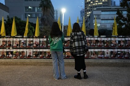 Two women observe photos of hostages held in the Gaza Strip, which are plastered to a fence in Tel Aviv, Israel, Wednesday, Jan. 15, 2025. (AP) Two women observe photos of hostages held in the Gaza Strip, which are plastered to a fence in Tel Aviv, Israel, Wednesday, Jan. 15, 2025. (AP)