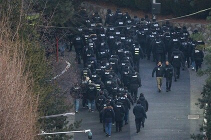 Police officers enter the compound of the presidential residence of impeached South Korea President Yoon Suk Yeol in Seoul on January 15, 2025. Impeached South Korean leader Yoon Suk Yeol was arrested on January 15 over his failed martial law bid, ending a weeks-long standoff with authorities and becoming the first sitting president to be detained in the nation's history. (Photo by ANTHONY WALLACE / AFP) (AFP) Police officers enter the compound of the presidential residence of impeached South Korea President Yoon Suk Yeol in Seoul on January 15, 2025. Impeached South Korean leader Yoon Suk Yeol was arrested on January 15 over his failed martial law bid, ending a weeks-long standoff with authorities and becoming the first sitting president to be detained in the nation's history. (Photo by ANTHONY WALLACE / AFP) (AFP)