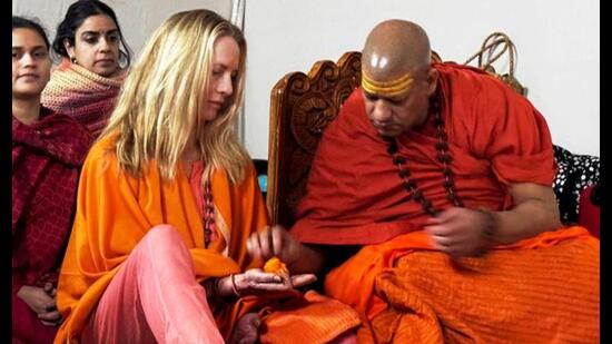 Philanthropist Laurene Powell Jobs, wife of Apple co-founder Steve Jobs, receives spiritual initiation from her guru Niranjani Peethadheeshwar Swami Kailashanand Giri, amid the Mahakumbh, in Prayagraj. (PTI Photo)