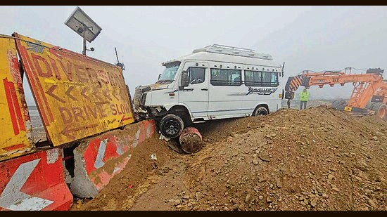 The tempo traveller that hit a diversion board on an under-construction flyover in Karnal. (HT Photo)