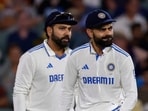 India's captain Rohit Sharma, left, looks on as teammate Virat Kohli rubs to shine the ball before passing it to the bowler India's captain Rohit Sharma, left, looks on as teammate Virat Kohli rubs to shine the ball before passing it to the bowler