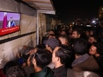 People watch the live television broadcast of a press conference being addressed by Qatar Prime Minister Sheikh Mohammed bin Abdulrahman bin Jassim Al-Thani, along a street in Khan Yunis in the southern Gaza Strip on January 15, 2025. People watch the live television broadcast of a press conference being addressed by Qatar Prime Minister Sheikh Mohammed bin Abdulrahman bin Jassim Al-Thani, along a street in Khan Yunis in the southern Gaza Strip on January 15, 2025.