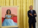FILE PHOTO: Former U.S. President Barack Obama reacts as he stands next to former first lady Michelle Obama's official White House portrait, painted by Sharon Sprung, in the East Room of the White House.