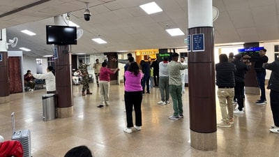 In a post on X, passengers in the airport can be seen doing stretching exercises guided by a CISF official. (X/@ProfMaterial)