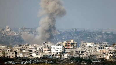 This picture taken from the Israeli side of the border with the Gaza Strip shows smoke plumes rising from explosions above destroyed buildings in the northern Gaza Strip on January 16, 2025, following the announcement of a truce amid the ongoing war between Israel and Hamas. (Photo by Menahem KAHANA / AFP) (AFP) This picture taken from the Israeli side of the border with the Gaza Strip shows smoke plumes rising from explosions above destroyed buildings in the northern Gaza Strip on January 16, 2025, following the announcement of a truce amid the ongoing war between Israel and Hamas. (Photo by Menahem KAHANA / AFP) (AFP)