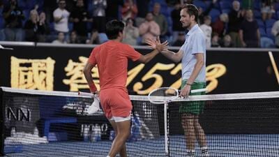 Learner Tien, left, is congratulated after winning his second round match against Daniil Medvedev at the Australian Open. (AP) Learner Tien, left, is congratulated after winning his second round match against Daniil Medvedev at the Australian Open. (AP)