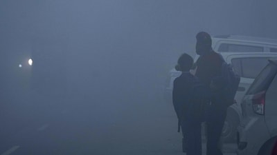School students wait for transport amid dense morning fog (PTI) School students wait for transport amid dense morning fog (PTI)