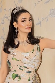 The art connoisseur looks regal in a ruched floral Dolce & Gabanna gown with a thigh-high slit. The look is styled with necklace, floral motif earrings and bejewelled headgear, all from RK Jewellers.  
JEWELLERY:  RK jewellers