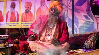 Rabri Baba, also known as Shri Mahant Devgiri of Shri Panchayati Akhada Mahanirvani, has caught the eye of several devotees for his unique service where he boils milk and prepares a creamy dish known as Rabri to serve devotees from 8.00 am till night. (PTI) Rabri Baba, also known as Shri Mahant Devgiri of Shri Panchayati Akhada Mahanirvani, has caught the eye of several devotees for his unique service where he boils milk and prepares a creamy dish known as Rabri to serve devotees from 8.00 am till night. (PTI)