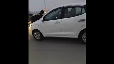 A man for dragged on the bonnet of a car for almost a kilometer on Moradabad-Agra highway when he went to confront hi wife and her alleged boyfriend. (X/@Live_Hindustan) A man for dragged on the bonnet of a car for almost a kilometer on Moradabad-Agra highway when he went to confront hi wife and her alleged boyfriend. (X/@Live_Hindustan)