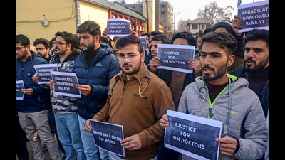 Srinagar: Medical students from Government Medical College (GMC) Srinagar, holding placards take part in a silent protest against the reduction of Open Merit (OM) seats in postgraduate admissions under the NEET PG framework, in Srinagar, Monday, Dec. 9, 2024. (PTI Photo) (PTI) Srinagar: Medical students from Government Medical College (GMC) Srinagar, holding placards take part in a silent protest against the reduction of Open Merit (OM) seats in postgraduate admissions under the NEET PG framework, in Srinagar, Monday, Dec. 9, 2024. (PTI Photo) (PTI)