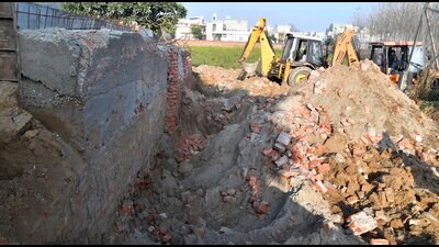 The Municipal Corporation’s (MC) efforts to demolish the boundary wall of a colony, Bhagya Homes, linking Rahon Road with Tajpur Road and Chandigarh Road faced another setback on Friday. Despite mobilising heavy machinery and a pre-planned strategy, the demolition drive was halted midway due to operational challenges. (Manish/HT) The Municipal Corporation’s (MC) efforts to demolish the boundary wall of a colony, Bhagya Homes, linking Rahon Road with Tajpur Road and Chandigarh Road faced another setback on Friday. Despite mobilising heavy machinery and a pre-planned strategy, the demolition drive was halted midway due to operational challenges. (Manish/HT)