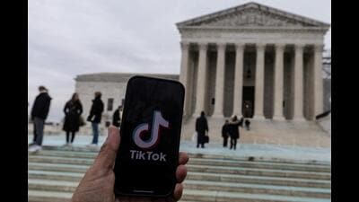 The TikTok logo is displayed on a mobile phone next to the US Supreme Court, in this picture illustration taken on Friday. (REUTERS) The TikTok logo is displayed on a mobile phone next to the US Supreme Court, in this picture illustration taken on Friday. (REUTERS)