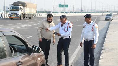Traffic police challan a man for driving on the wrong side on the Dwarka Expressway in March 14. (Parveen Kumar/HT Photo)