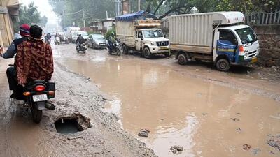 Waterlogging and an open pothole in Bijwasan village on Friday. (Ajay Aggarwal/HT Photo) Waterlogging and an open pothole in Bijwasan village on Friday. (Ajay Aggarwal/HT Photo)