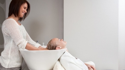 The unusual neck position, neck rotation or sudden jerking movements during vigorous shampooing can push against one of the major blood vessels that supply blood to the back and bottom of the brain. (Shutterstock) The unusual neck position, neck rotation or sudden jerking movements during vigorous shampooing can push against one of the major blood vessels that supply blood to the back and bottom of the brain. (Shutterstock)