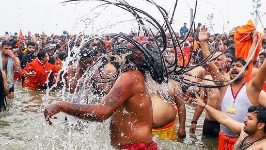 Prayagraj, Jan 14 (ANI): Naga sadhus take 'Amrit Snan' at Triveni Sangam on the occasion of 'Makar Sankranti' during the Maha Kumbh 2025, in Prayagraj on Tuesday. (ANI Photo) (Naeem Ansari)