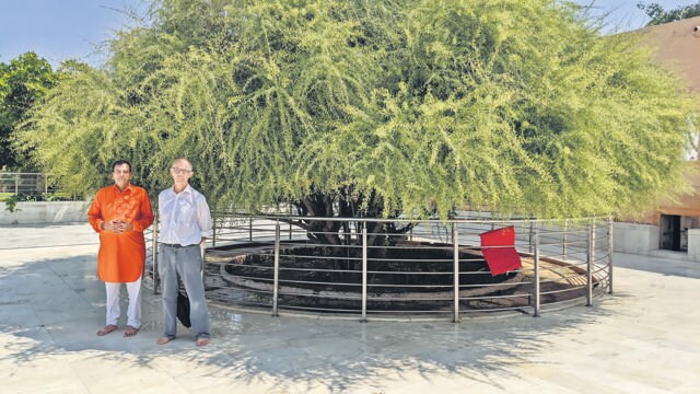 With the priest at Lalasar temple, beside the kankeri tree under which Guru Jambhoji died. (Ganpat Bishnoi) With the priest at Lalasar temple, beside the kankeri tree under which Guru Jambhoji died. (Ganpat Bishnoi)