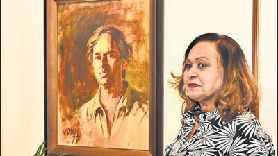 Agnela Fernandes, standing next to husband late John Fernandes’ self potrait. Vesavar Art Gallery in Camp showcases solo art exhibition ‘Veritas: An Odyssey of Brush and Soul’ featuring works of John. (HT) Agnela Fernandes, standing next to husband late John Fernandes’ self potrait. Vesavar Art Gallery in Camp showcases solo art exhibition ‘Veritas: An Odyssey of Brush and Soul’ featuring works of John. (HT)