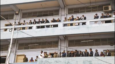 Lawyers and others watch Sanjay Roy being brought to the Sealdah court in Kolkata on Saturday. (PTI) Lawyers and others watch Sanjay Roy being brought to the Sealdah court in Kolkata on Saturday. (PTI)