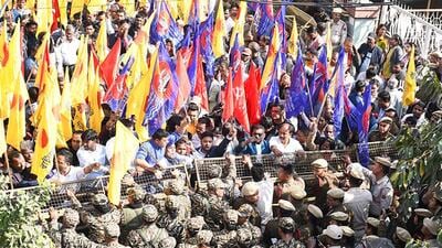 Security personnel try to control members of the Asom Sonmilito Morcha (ASOM) during their protest against the Umrangso Coal Mine incident outside Assam Mineral Development Corporation office in Guwahati on Thursday. (ANI)