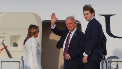 US President-elect Donald Trump waves beside his wife Melania Trump and their son Barron as they board a US government aircraft at Palm Beach International Airport to reach Washington, DC, for his inauguration on January 20. (AFP) US President-elect Donald Trump waves beside his wife Melania Trump and their son Barron as they board a US government aircraft at Palm Beach International Airport to reach Washington, DC, for his inauguration on January 20. (AFP)