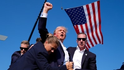 Donald Trump was surrounded by U.S. Secret Service agents at a campaign rally, July 13, 2024, in Butler, Pa. (AP Photo/Evan Vucci, File) (AP) Donald Trump was surrounded by U.S. Secret Service agents at a campaign rally, July 13, 2024, in Butler, Pa. (AP Photo/Evan Vucci, File) (AP)