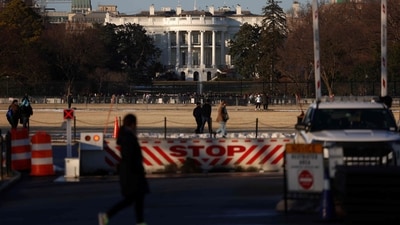 People walk past the White House in Washington as the US capital prepares for the inauguration of US President-elect Donald Trump. Donald Trump confirmed that his inauguration as US president on January 20 will move indoors due to expected freezing weather. (AFP) People walk past the White House in Washington as the US capital prepares for the inauguration of US President-elect Donald Trump. Donald Trump confirmed that his inauguration as US president on January 20 will move indoors due to expected freezing weather. (AFP)