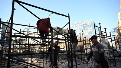 Workers remove scaffolding along the parade route on Pennsylvania Avenue in Washington, DC as the US capital prepares for the inauguration of US President-elect Donald Trump. (AFP) Workers remove scaffolding along the parade route on Pennsylvania Avenue in Washington, DC as the US capital prepares for the inauguration of US President-elect Donald Trump. (AFP)