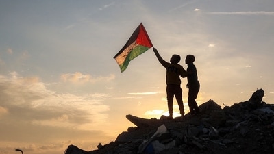 Israel's high-level security cabinet approved a ceasefire and hostage-prisoner exchange deal with Hamas on Saturday, paving the way for a weeks-long pause from Sunday to the 15 months of fighting in Gaza. In pic: A boy runs with a Palestinian flag atop a mound of rubble at a camp for people displaced by conflict in Bureij in the central Gaza Strip on January 17, 2025 following the announcement of a truce amid the ongoing war between Israel and Hamas. (AFP) Israel's high-level security cabinet approved a ceasefire and hostage-prisoner exchange deal with Hamas on Saturday, paving the way for a weeks-long pause from Sunday to the 15 months of fighting in Gaza. In pic: A boy runs with a Palestinian flag atop a mound of rubble at a camp for people displaced by conflict in Bureij in the central Gaza Strip on January 17, 2025 following the announcement of a truce amid the ongoing war between Israel and Hamas. (AFP)
