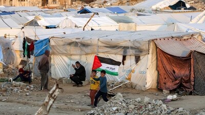 The ongoing assault has displaced almost all of Gaza's 2.3 million residents and raised alarms from global humanitarian organisations, including the world’s leading hunger monitor. In pic: A boy runs with a Palestinian flag inscribed with the Arabic phrase "we sacrifice ourselves for the nation", past tents at a camp for people displaced by conflict in Bureij in the central Gaza Strip on January 17, 2025. (AFP) The ongoing assault has displaced almost all of Gaza's 2.3 million residents and raised alarms from global humanitarian organisations, including the world’s leading hunger monitor. In pic: A boy runs with a Palestinian flag inscribed with the Arabic phrase "we sacrifice ourselves for the nation", past tents at a camp for people displaced by conflict in Bureij in the central Gaza Strip on January 17, 2025. (AFP)