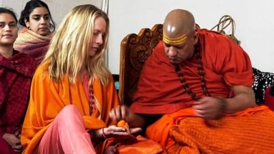 Philanthropist Laurene Powell Jobs, wife of Apple co-founder Steve Jobs, receives spiritual initiation from her guru Niranjani Peethadheeshwar Swami Kailashanand Giri, at the Mahakumbh, in Prayagraj. (PTI) Philanthropist Laurene Powell Jobs, wife of Apple co-founder Steve Jobs, receives spiritual initiation from her guru Niranjani Peethadheeshwar Swami Kailashanand Giri, at the Mahakumbh, in Prayagraj. (PTI)