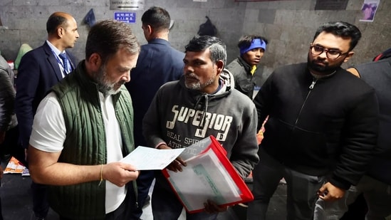 Leader Of Opposition in the Lok Sabha Rahul Gandhi interacts with patients and their attendants waiting for treatments at the AIIMS, in New Delhi, Thursday night. (PTI)