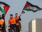 Members of the Palestinian civil emergency service celebrate despite a delay in the ceasefire between Israel and Hamas over the hostage list, in Gaza City,