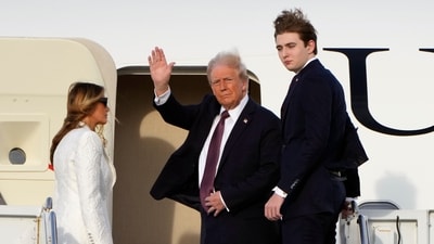 President-elect Donald Trump, standing with Melania and Barron Trump, waves as they board an Air Force Special Mission airplane at Palm Beach International Airport Saturday, Jan. 18, 2025 in West Palm Beach, Fla., enroute to Washington. (AP Photo/Lynne Sladky)(AP Photo/Lynne Sladky) (AP) President-elect Donald Trump, standing with Melania and Barron Trump, waves as they board an Air Force Special Mission airplane at Palm Beach International Airport Saturday, Jan. 18, 2025 in West Palm Beach, Fla., enroute to Washington. (AP Photo/Lynne Sladky)(AP Photo/Lynne Sladky) (AP)