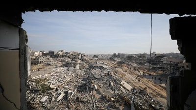 Displaced Palestinians walk past the rubble as they attempt to return to their homes, following a delay in the ceasefire between Israel and Hamas over the hostage list, in the northern Gaza Strip, January 19, 2025.&nbsp; (REUTERS)