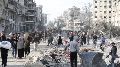 Displaced Palestinians walk past the rubble as they attempt to return to their homes, following a delay in the ceasefire between Israel and Hamas over the hostage list, in the northern Gaza Strip, January 19, 2025.&nbsp; (REUTERS)