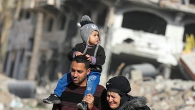 Displaced Palestinians walk past the rubble as they attempt to return to their homes, following a delay in the ceasefire between Israel and Hamas over the hostage list, in the northern Gaza Strip, January 19, 2025.&nbsp; (REUTERS)