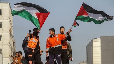 Members of the Palestinian civil emergency service celebrate despite a delay in the ceasefire between Israel and Hamas over the hostage list, in Gaza City, (REUTERS)