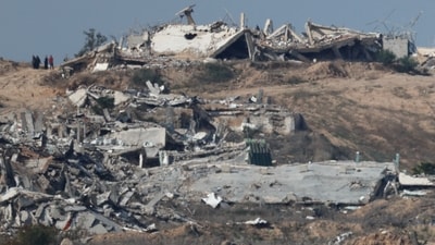 Displaced Palestinians walk past rubble as they attempt to return to their homes, amid a ceasefire between Israel and Hamas, as seen from Israel, January 19, 2025.&nbsp; (REUTERS)