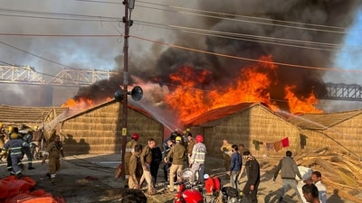 Smoke billows out after a fire broke out in a camp during Mahakumbh at Sangam in Prayagraj. Fire tenders were rushed to the spot to put out the fire. (PTI) Smoke billows out after a fire broke out in a camp during Mahakumbh at Sangam in Prayagraj. Fire tenders were rushed to the spot to put out the fire. (PTI)