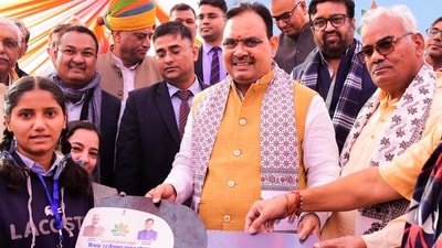 FILE: Rajasthan Chief Minister Bhajanlal Sharma, center, state Education Minister Madan Dilawar and others felicitate a young woman during an employment exhibition on completion of one year of the state government. (PTI) FILE: Rajasthan Chief Minister Bhajanlal Sharma, center, state Education Minister Madan Dilawar and others felicitate a young woman during an employment exhibition on completion of one year of the state government. (PTI)