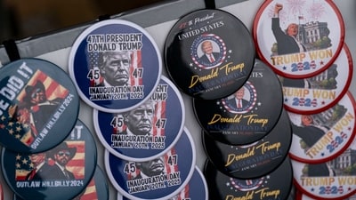 A street vendor displays buttons for sale ahead of the 60th presidential inauguration in Washington, DC, US, on Saturday, Jan. 18, 2025. Monday's presidential inauguration promises to be one of the coldest on record, prompting US officials to move the ceremony indoors to the Capitol Rotunda. ( Al Drago/Bloomberg)